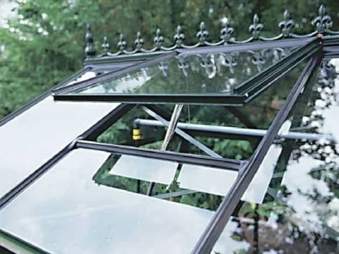 Linear actuator opening a greenhouse window vent where IP65 or higher dust and water protection rating is recommended